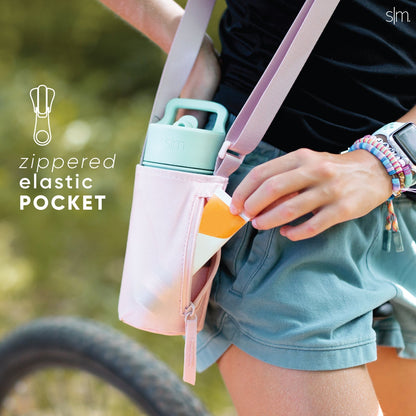 Light pink kids adventure sling bag with adjustable straps, displayed against a soft pastel background. Product features view showing the bag's design and construction details.