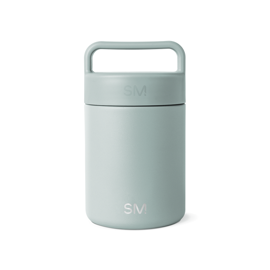 Sage green glass jar with white background, featuring a minimalist design and neutral aesthetic