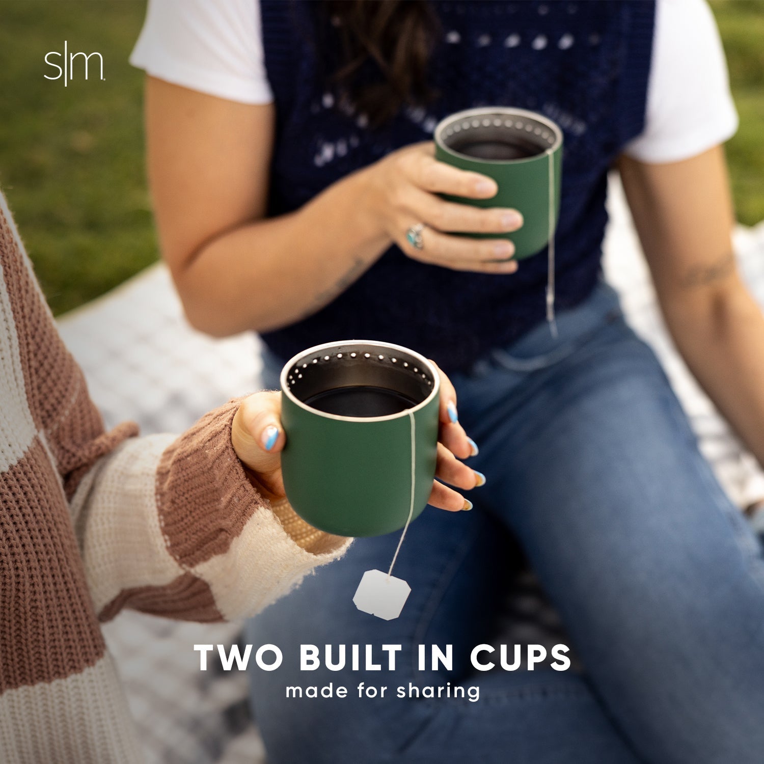 Two people holding forest green insulated cups with white rim detailing. One person wears a white shirt. Navy accents visible on the cups.