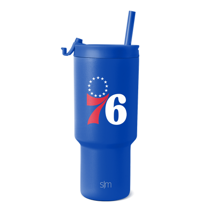 Royal blue tumbler with white text and red swoosh design element